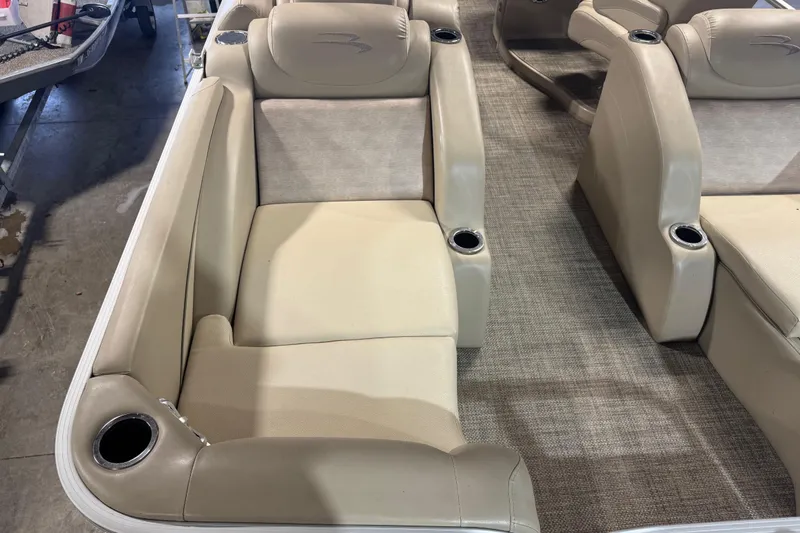 Slide: The Image of 2014 Bennington 2275 GL boat interior with beige seating and cup holders. - 7