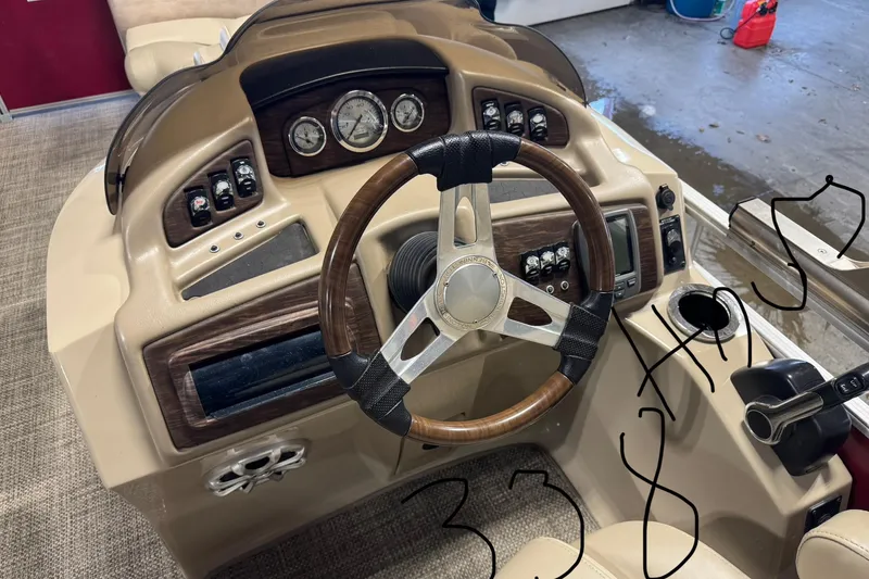 Slide: The Image of 2014 Bennington 2275 GL boat dashboard with steering wheel and control panel. - 9