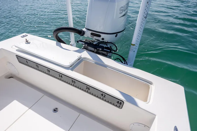 Slide: The Image of 2024 Layton Bay 22 boat with Suzuki outboard motor on water. - 11