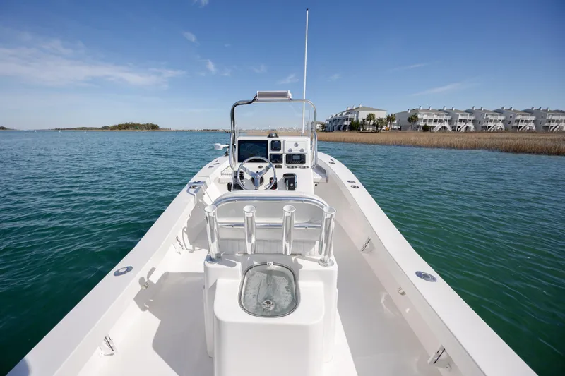 Slide: The Image of 2024 Layton Bay 22 boat on calm water, clear sky, coastal background. - 12