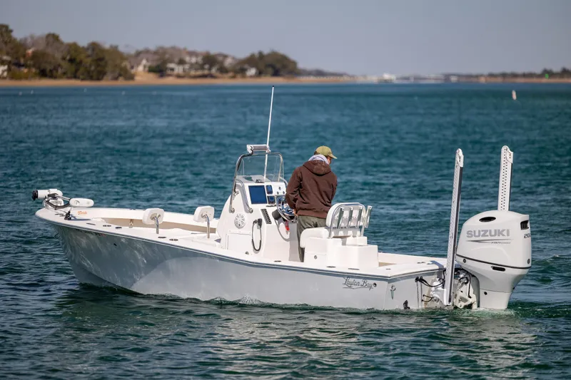 Slide: The Image of 2024 Layton Bay 22 boat on water with Suzuki engine, person onboard. - 5