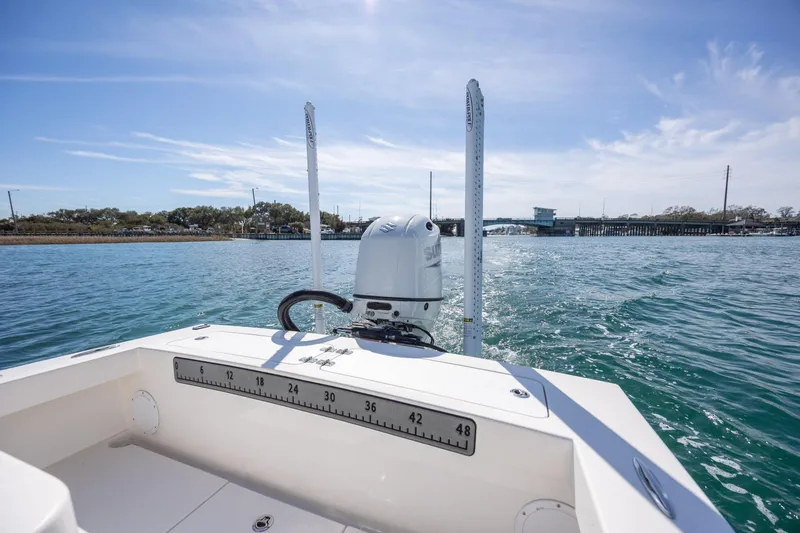 Slide: The Image of 2024 Layton Bay 22 boat on water, featuring outboard motor and measuring scale. - 8