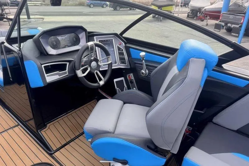 Slide: The Image of 2024 MasterCraft X24 boat interior with modern dashboard and blue-gray seating. - 16