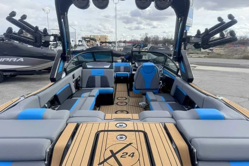Slide: The Image of 2024 MasterCraft X24 boat interior with blue and gray seating, showcasing luxury and style. - 5