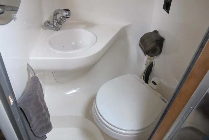 Slide: The Image of Compact bathroom in 2006 Chaparral Signature 240 boat with sink and toilet. - 13