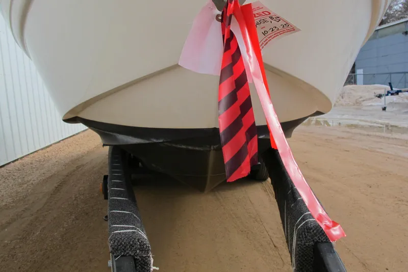 Slide: The Image of 2006 Chaparral Signature 240 boat on trailer with red caution tape. - 3