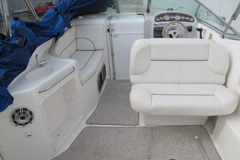 Slide: The Image of 2006 Chaparral Signature 240 boat interior with white seating and compact sink area. - 5