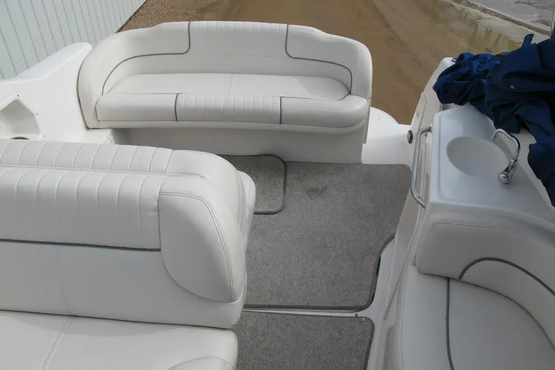 Slide: The Image of 2006 Chaparral Signature 240 boat interior with white seating and carpeted floor. - 6
