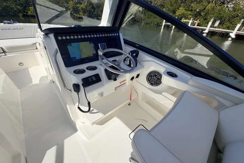 Slide: The Image of Helm of 2026 World Cat 265 DC-X boat with modern controls and navigation system. - 12