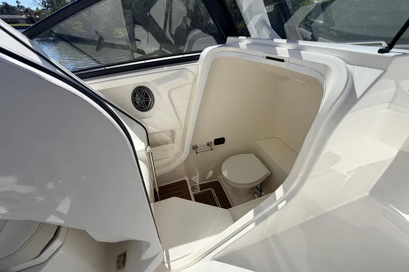 Slide: The Image of 2026 World Cat 265 DC-X boat interior with compact marine toilet and sleek design. - 15