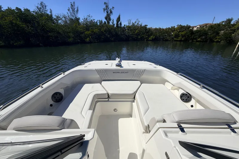 Slide: The Image of 2026 World Cat 265 DC-X boat interior with spacious seating on a calm waterway. - 16