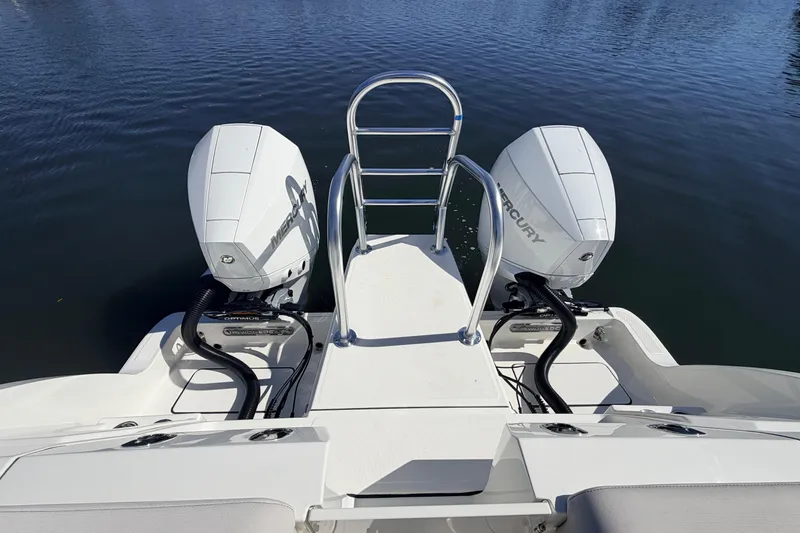 Slide: The Image of 2026 World Cat 265 DC-X boat with dual Mercury outboard engines on calm water. - 6