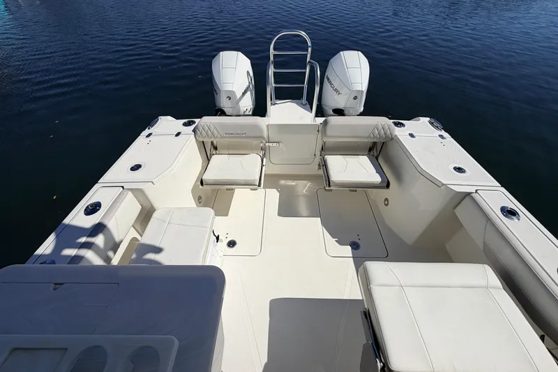 Slide: The Image of 2026 World Cat 265 DC-X boat interior with seating and dual engines on calm water. - 8