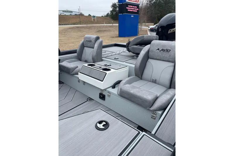 Slide: The Image of 2026 Avid 18 Vertex boat interior with gray seating and storage compartments. - 2