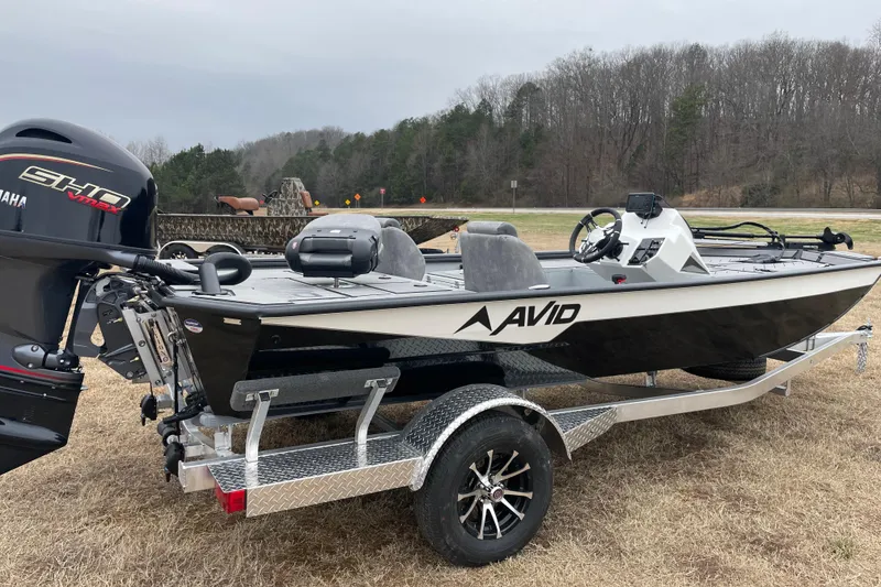 Slide: The Image of Avid 18 Vertex 2026 boat on trailer with Yamaha engine, parked on grass. - 6