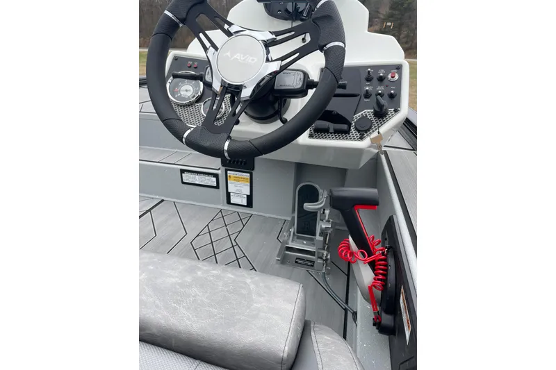 Slide: The Image of 2026 Avid 18 Vertex boat cockpit with steering wheel and control panel. - 7