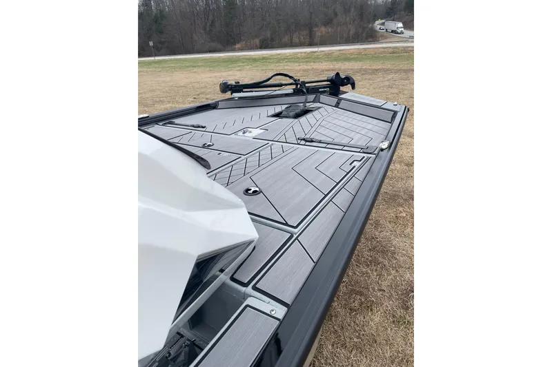 Slide: The Image of 2026 Avid 18 Vertex boat deck with sleek design on grassy area. - 9