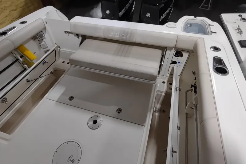 Slide: The Image of 2015 Boston Whaler 285 Conquest boat interior with seating and storage compartments. - 11