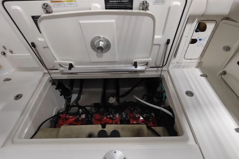 Slide: The Image of Open engine compartment of 2015 Boston Whaler 285 Conquest boat, showcasing internal components. - 12