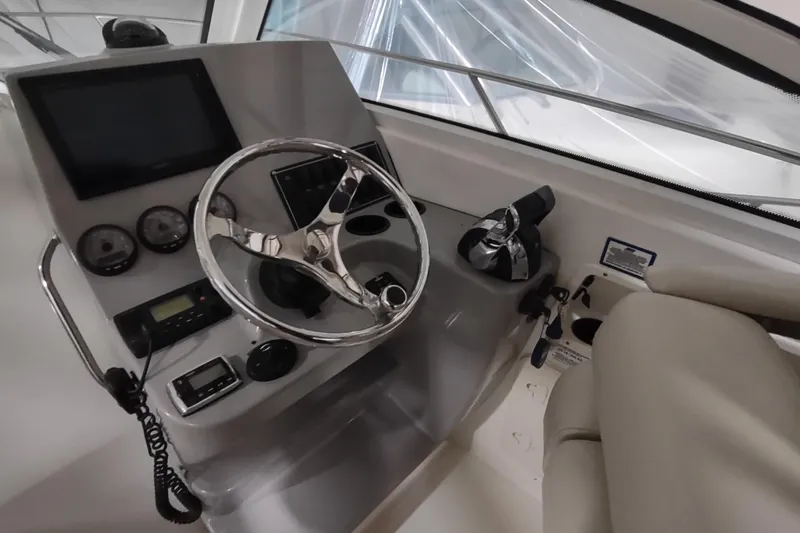 Slide: The Image of 2015 Boston Whaler 285 Conquest helm with steering wheel and control panel. - 14