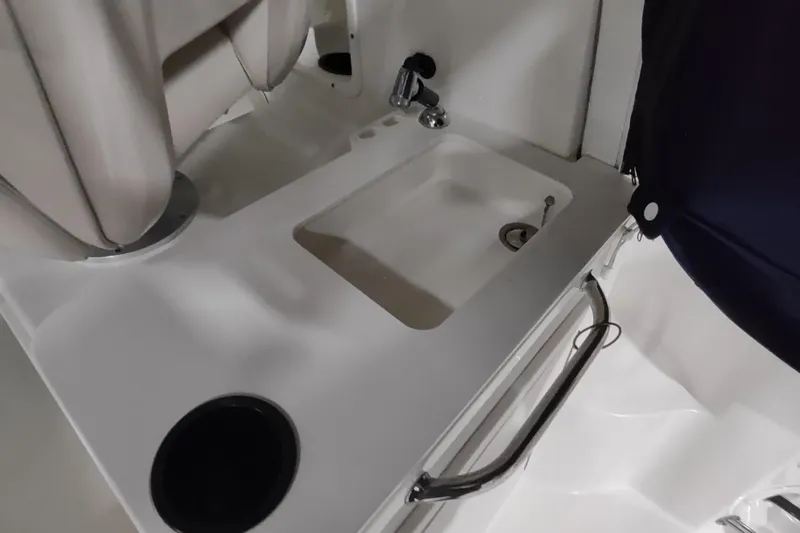 Slide: The Image of Interior of 2015 Boston Whaler 285 Conquest boat featuring a compact sink area. - 19