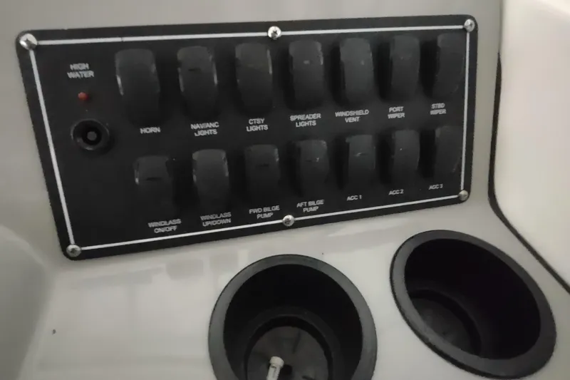 Slide: The Image of Control panel of a 2015 Boston Whaler 285 Conquest boat with labeled switches. - 24
