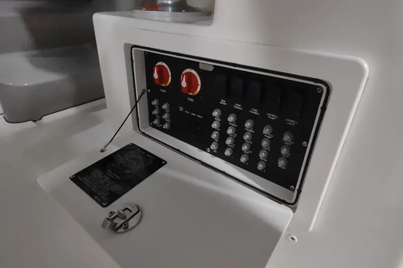 Slide: The Image of Control panel of a 2015 Boston Whaler 285 Conquest boat, featuring switches and dials. - 25