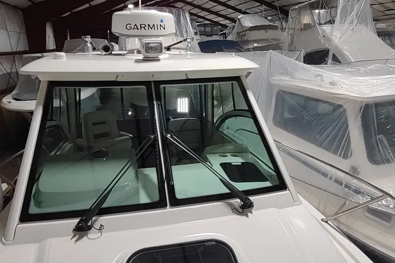 Slide: The Image of 2015 Boston Whaler 285 Conquest boat in storage, featuring Garmin equipment. - 27