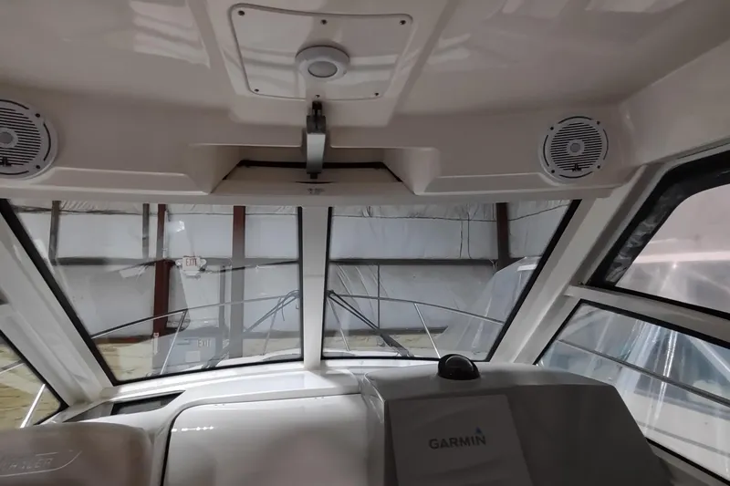 Slide: The Image of 2015 Boston Whaler 285 Conquest interior with Garmin navigation system and speakers. - 28