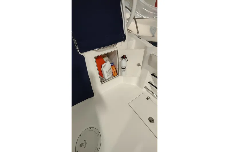 Slide: The Image of 2015 Boston Whaler 285 Conquest storage compartment with safety equipment and supplies. - 30