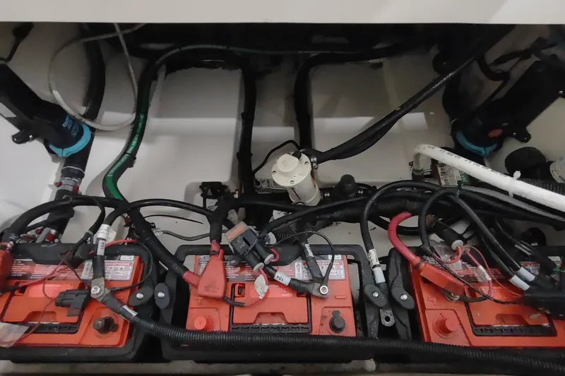 Slide: The Image of Engine compartment of a 2015 Boston Whaler 285 Conquest with visible batteries and wiring. - 32