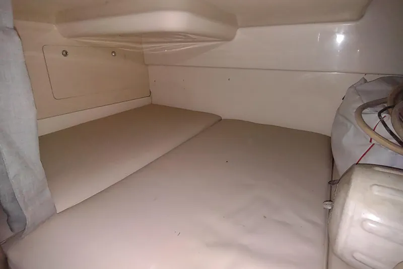 Slide: The Image of 2015 Boston Whaler 285 Conquest cabin interior with beige cushions and storage. - 34