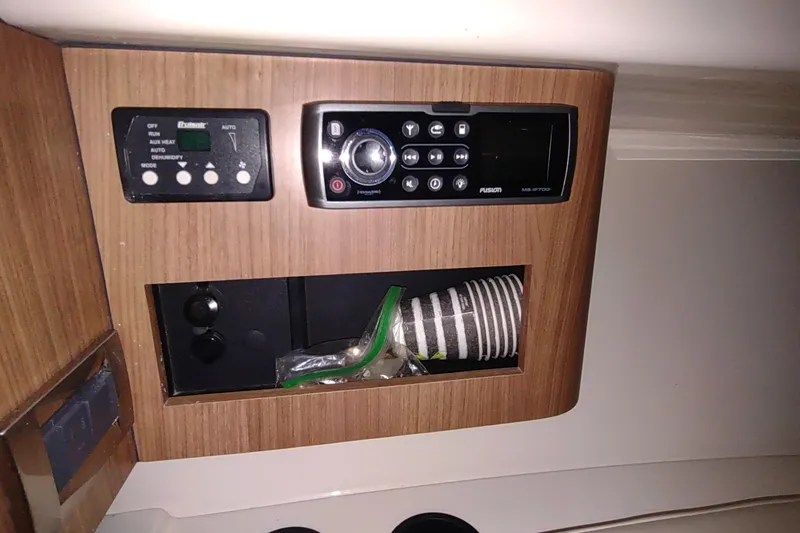 Slide: The Image of 2015 Boston Whaler 285 Conquest interior with control panel and storage compartment. - 38