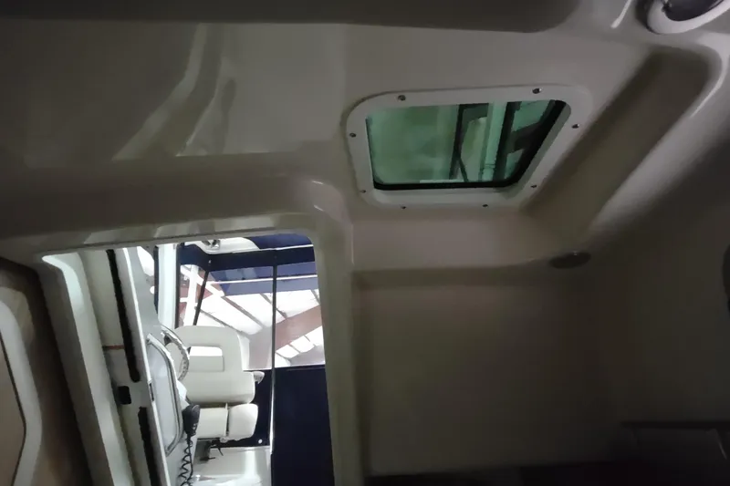 Slide: The Image of Interior cabin view of 2015 Boston Whaler 285 Conquest boat with overhead hatch. - 47