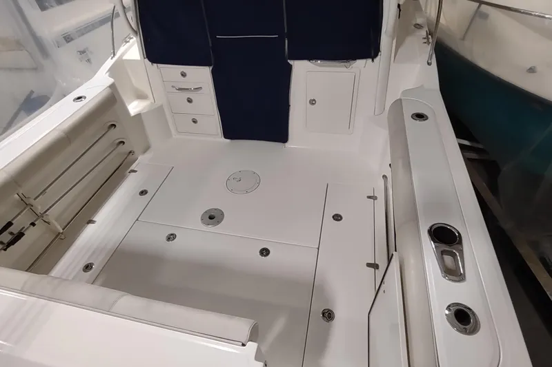 Slide: The Image of 2015 Boston Whaler 285 Conquest boat interior with storage compartments and seating. - 56