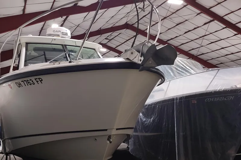 Slide: The Image of 2015 Boston Whaler 285 Conquest boat in indoor storage facility. - 57