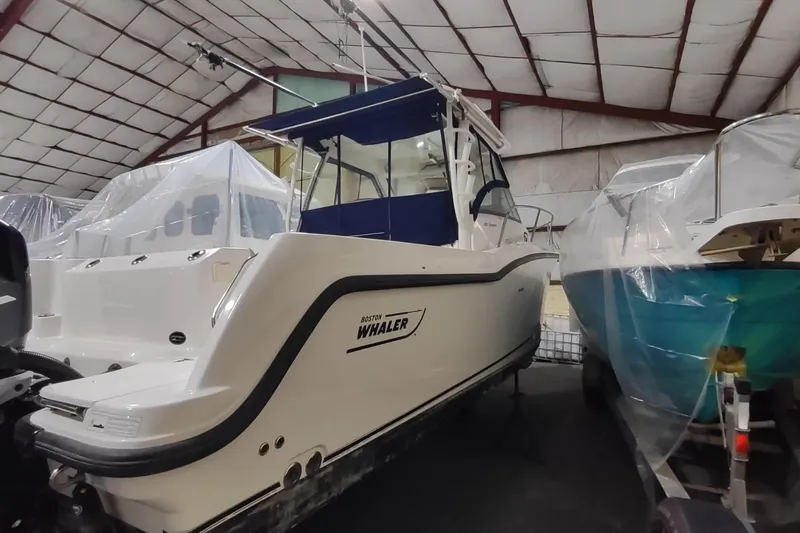 Slide: The Image of 2015 Boston Whaler 285 Conquest boat in storage, covered and protected indoors. - 58