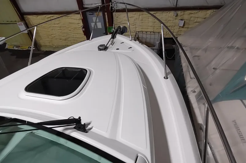 Slide: The Image of 2015 Boston Whaler 285 Conquest boat deck with hatch and railing in storage. - 6