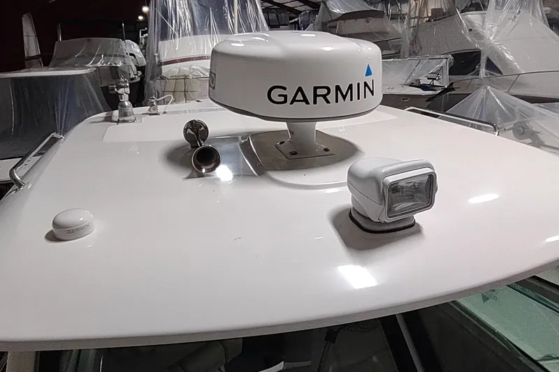 Slide: The Image of 2015 Boston Whaler 285 Conquest boat with Garmin radar and spotlight on deck. - 8