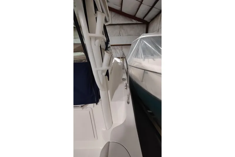 Slide: The Image of 2015 Boston Whaler 285 Conquest in storage, showcasing side view and railings. - 9