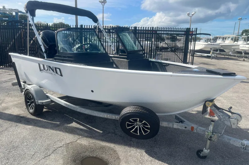 Slide: The Image of 2026 Lund 1650 Rebel XL Sport boat on trailer, parked outdoors. - 3