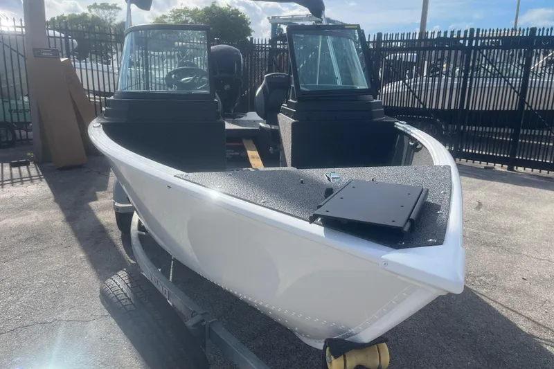 Slide: The Image of 2026 Lund 1650 Rebel XL Sport boat on trailer, parked outdoors. - 4