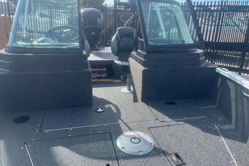 Slide: The Image of 2026 Lund 1650 Rebel XL Sport boat interior with dual consoles and seating. - 6