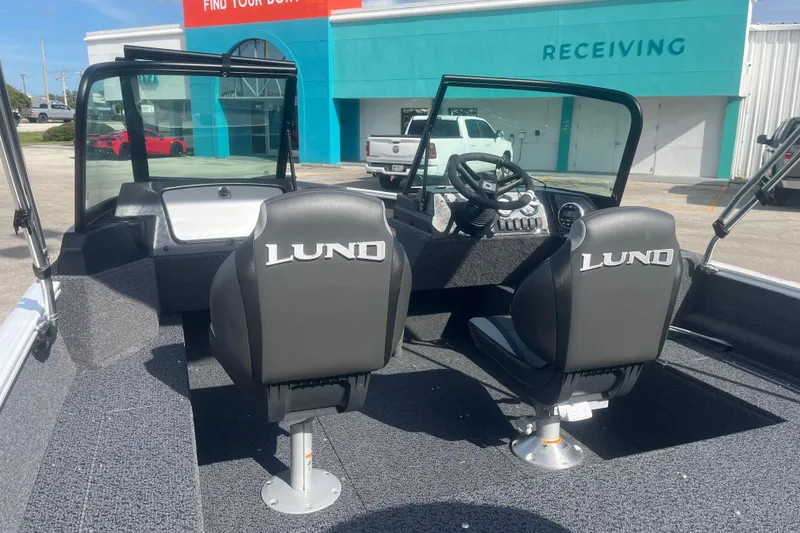 Slide: The Image of 2026 Lund 1650 Rebel XL Sport boat interior with two seats and steering console. - 9