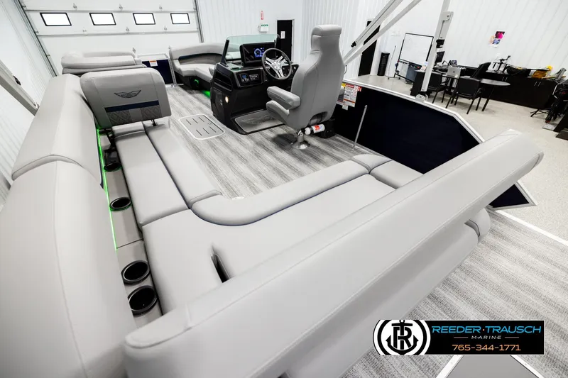 Slide: The Image of 2026 Bennington MLSF boat interior with modern seating and control console in showroom. - 11