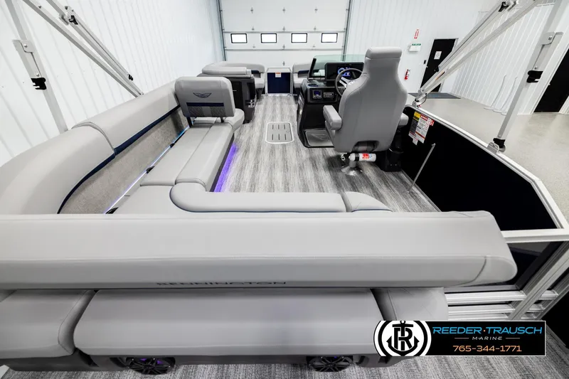 Slide: The Image of 2026 Bennington MLSF boat interior with modern seating and control panel in showroom. - 16