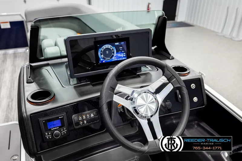 Slide: The Image of 2026 Bennington MLSF boat dashboard with steering wheel and digital display. - 32