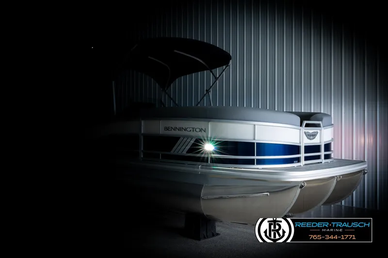 Slide: The Image of 2026 Bennington MLSF pontoon boat with canopy, showcased in a dimly lit setting. - 4