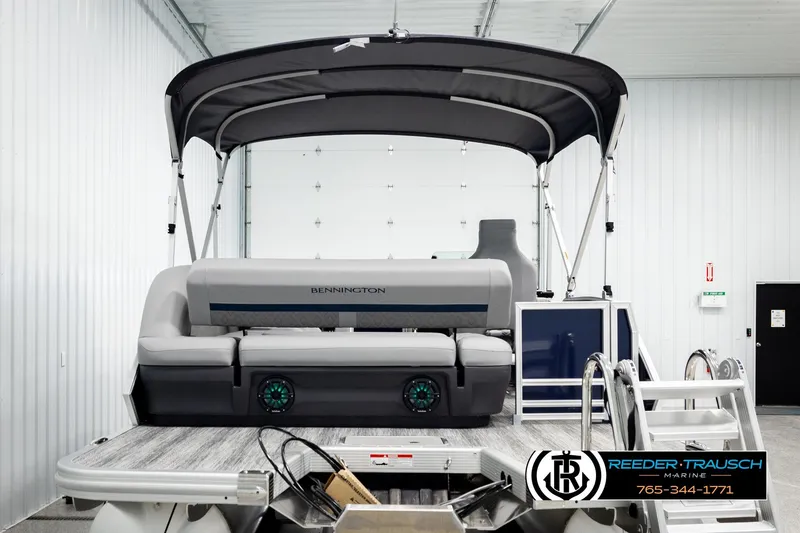 Slide: The Image of 2026 Bennington MLSF pontoon boat in showroom with canopy and seating. - 7