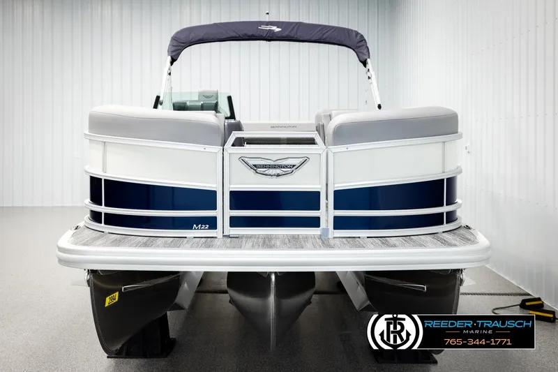 Slide: The Image of 2026 Bennington MLSF pontoon boat, blue and white design, displayed indoors. - 8